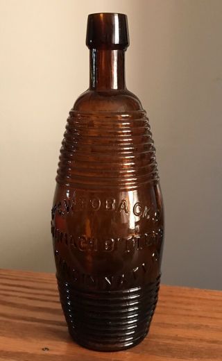 Antique Dr C.  W.  Robacks Stomach Bitters Cincinnati.  O Barrel Figural Amber Bottle