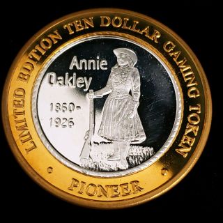 2001 G Pioneer Hotel Casino.  999 Silver Strike $10 Annie Oakley Token 2pc0107