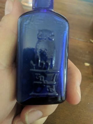 THE OWL DRUG CO.  COBALT BLUE POISON BOTTLE 3 1/4 inch tall triangle 7