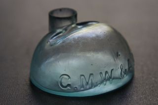UNUSUAL ANTIQUE HALF OVAL INK BOTTLE - EMBOSSED G.  M.  W.  & A.  A.  S. 2