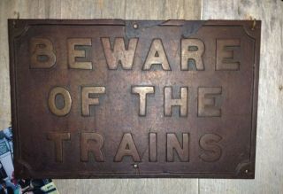 " Beware Of The Trains.  " Cast Iron Sign From Yesterday.  Broken,  Patched.