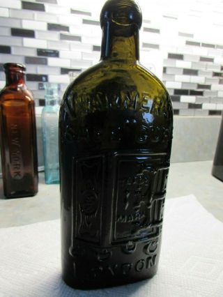 A Olive Green Warner Safe Cure Bottle