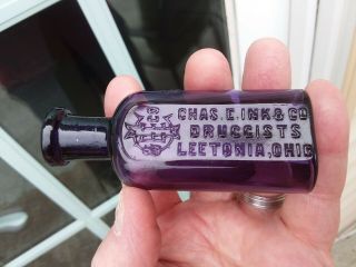 Deep Purple Leetonia,  Ohio Chas.  E.  Ink Druggists Label & Embossed Blown Bottle
