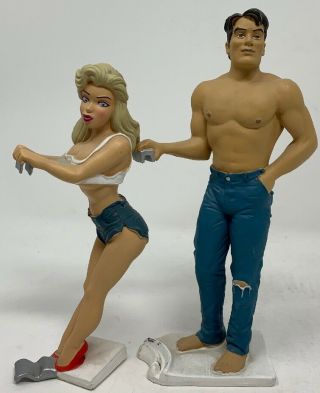 Set Of 2 Vintage Bottoms Up Can Holders By R.  Demars Figurine Sexy Girl & Hot Guy