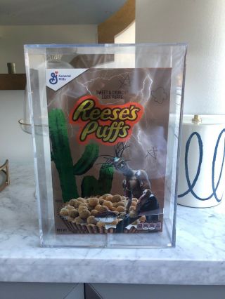 Travis Scott X Reese’s Puffs Cereal In Hand