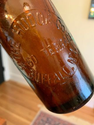The Hudor Co.  Buffalo N.  Y.  54 - 60 Terrace 7.  5 inch Amber Bottle 8