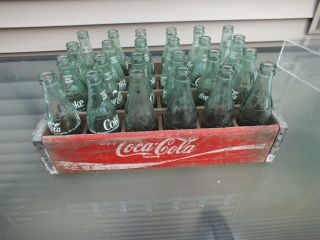 24 Each 6 1/2 Ounce Coca Cola Bottles In A Red Wooden Case