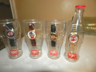 Four Coca Cola Watches In Glasses Bottle