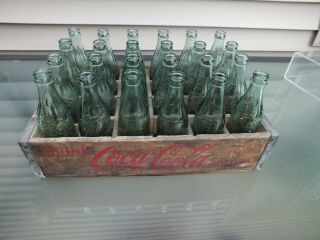24 Each 6 1/2 Ounce Coca Cola Bottles In A Red Coke Mark Wooden Case