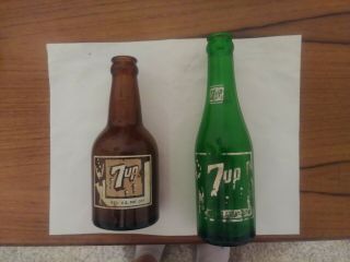 2 Very Rare 7 Up Bottles.  1 Amber And The Other Green.  Both In.