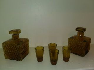 Two Glass Decanters And 4 Shot Glasses Possibly Amber Glass