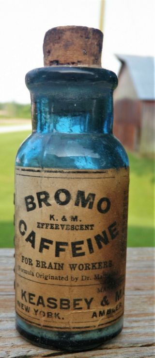 Bromo Caffeine.  Cobalt Blue,  Full Label,  Content & Embossed
