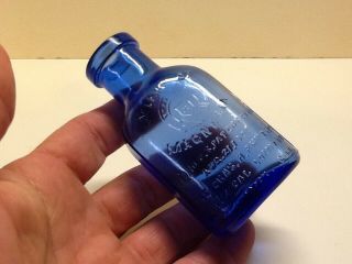 Small Fully Embossed Cobalt Blue Milk Of Magnesia Bottle.