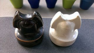 TWO ROMAN HELMET CABLE TOP PORCELAIN INSULATORS.  GLOSS WHITE AND MOLTEN COLORED 3