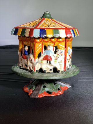 Antique Painted Cast Iron Carousel Bank/ Rotating Iron Merry Go Round