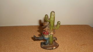 Antique Cast Iron Drunk Cowboy Holding On To A Cactus Bottle Opener