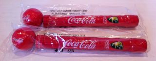 Two Coca Cola Bottle Bat Handles And Balls