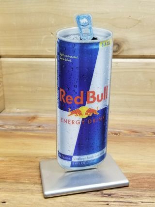 Red Bull Ad Sign W/ Metal Base And Plexiglass Sign.  Toggles Back And Forth