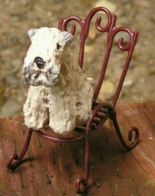 Soft Coated Wheaten Terrier On A Metal Garden Chair