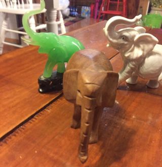 Three SMALL ELEPHANTS FIGURINES.  Wood,  Porcelain,  And Green Jade On Base 5