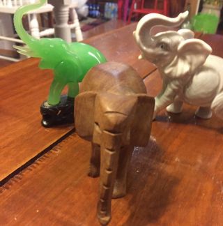 Three SMALL ELEPHANTS FIGURINES.  Wood,  Porcelain,  And Green Jade On Base 6