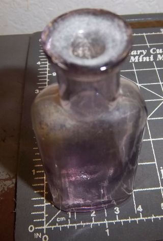 Vintage purple tinted glass bottle,  3.  5 x 1.  25 inches color 2