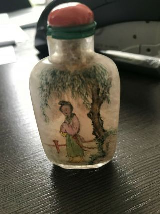 AN INSIDE - PAINTED CRYSTAL SNUFF BOTTLE.  WITH CORAL TOP. 7