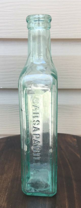 Ayers Lowell Massachusetts green Sarsaparilla bottle with partial label 8 1/2 