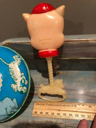 Vintage toy top and 1975 Warner Brothers,  Inc.  Porky Pig rattle. 3