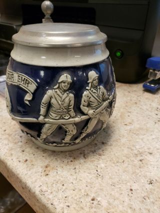german stein of firemen with hose and looks like a house fire.  coolectibles. 2