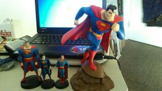 4 Superman Statues.  I Big,  2 Miniature Eaglemoss,  1 Superman Animated
