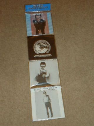 Elvis Costello,  4 X 7 " Vinyl Singles Pack In Foldout Hangable Pvc Wallet (grab3)
