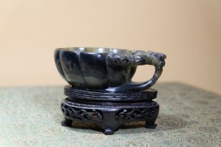 A Chinese Green Jade Stone Cup With Wood Stand.