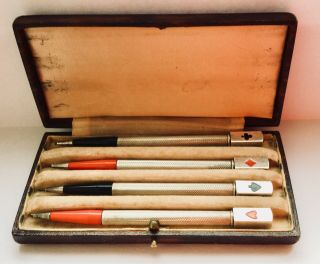 A Cased Set Of Four Sterling Silver And Enamel Bridge Pencils