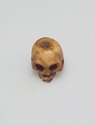 A lovely 19th century Meiji period Ojime of a skull. 5