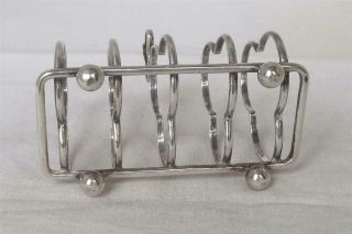 A ANTIQUE SOLID STERLING SILVER SHAPED TOAST RACK BIRMINGHAM 1912. 6