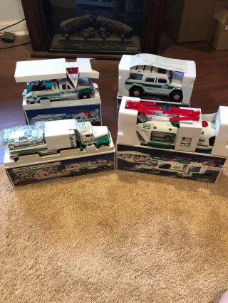 4 Hess Vehicles/trucks,  91,  94,  04 And Helicopter.  All Nib W/inserts