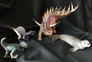 Schleich Kentrosaurus,  Velociraptor,  Spinosaurus Dinosaurs,  Seal - Set Of 4