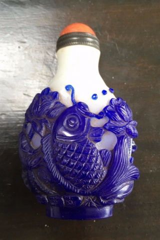 Chinese Snuff Bottle In White Glass With Deeply Carved Blue Overlay Of Fish