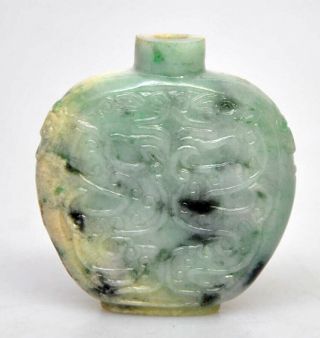 A Chinese Jade Snuff Bottle Spinach Green,  White And Russet.  Foo Dog Masks