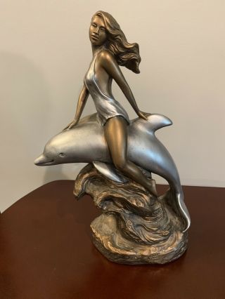 Girl Riding A Dolphin Statue