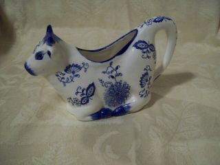 Vintage Porcelain Cow Creamer White With Blue Floral Cow Laying Down.  7 " Long.