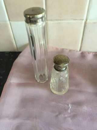 cut glass perfume bottle with a hallmarked silver top,  1 other vanity bottle 2