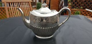 An Antique Silver Plated Tea Pot With Engraved Patterns By James Dixon & Sons.