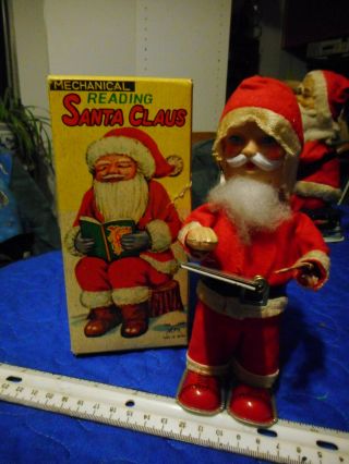 Vintage Reading Santa Claus Tin Wind Up Toy.  Alps,  Japan.