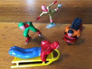 Antique Metal Toy Figures Man & Lady Ice Skaters And Two Sleds With Riders