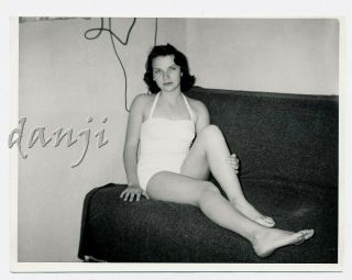 Swimsuit Girl With One - Leg - Up Sitting On The Sofa Staring Into Camera Old Photo