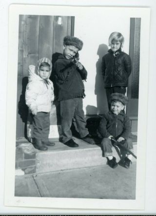 Boy Holding Toy Gun Pointed At Camera - Vintage Black & White Snapshot Photo