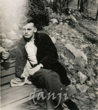 Studly Young Man Sitting On A Bench Pensively Smoking A Pipe Dramatic Old Photo