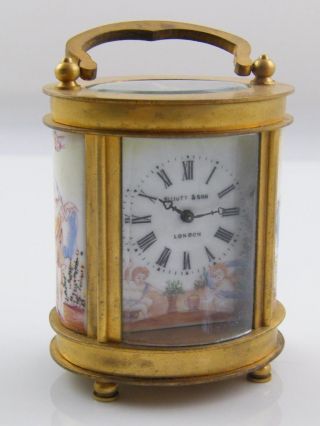 Oval Brass & Glass Carriage Clock With Porcelain Panels